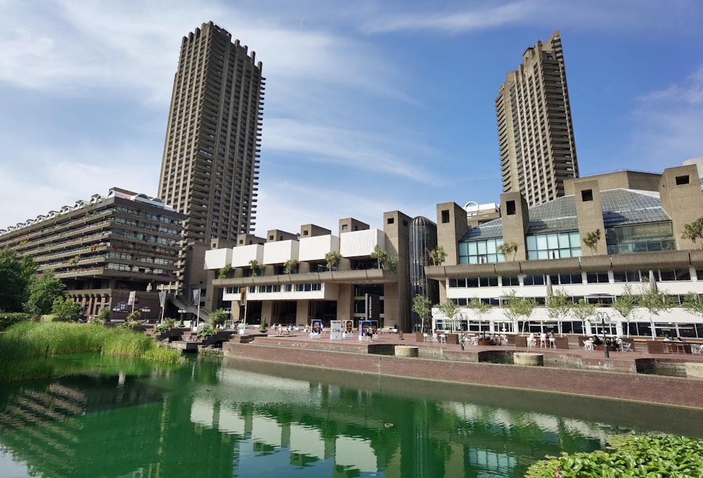 a body of water with buildings around it with Barbican Centre in the background