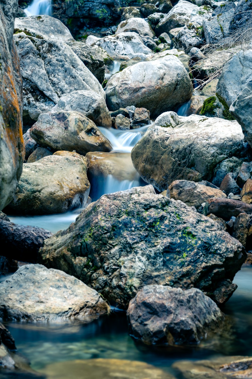 a stream of water flowing between rocks