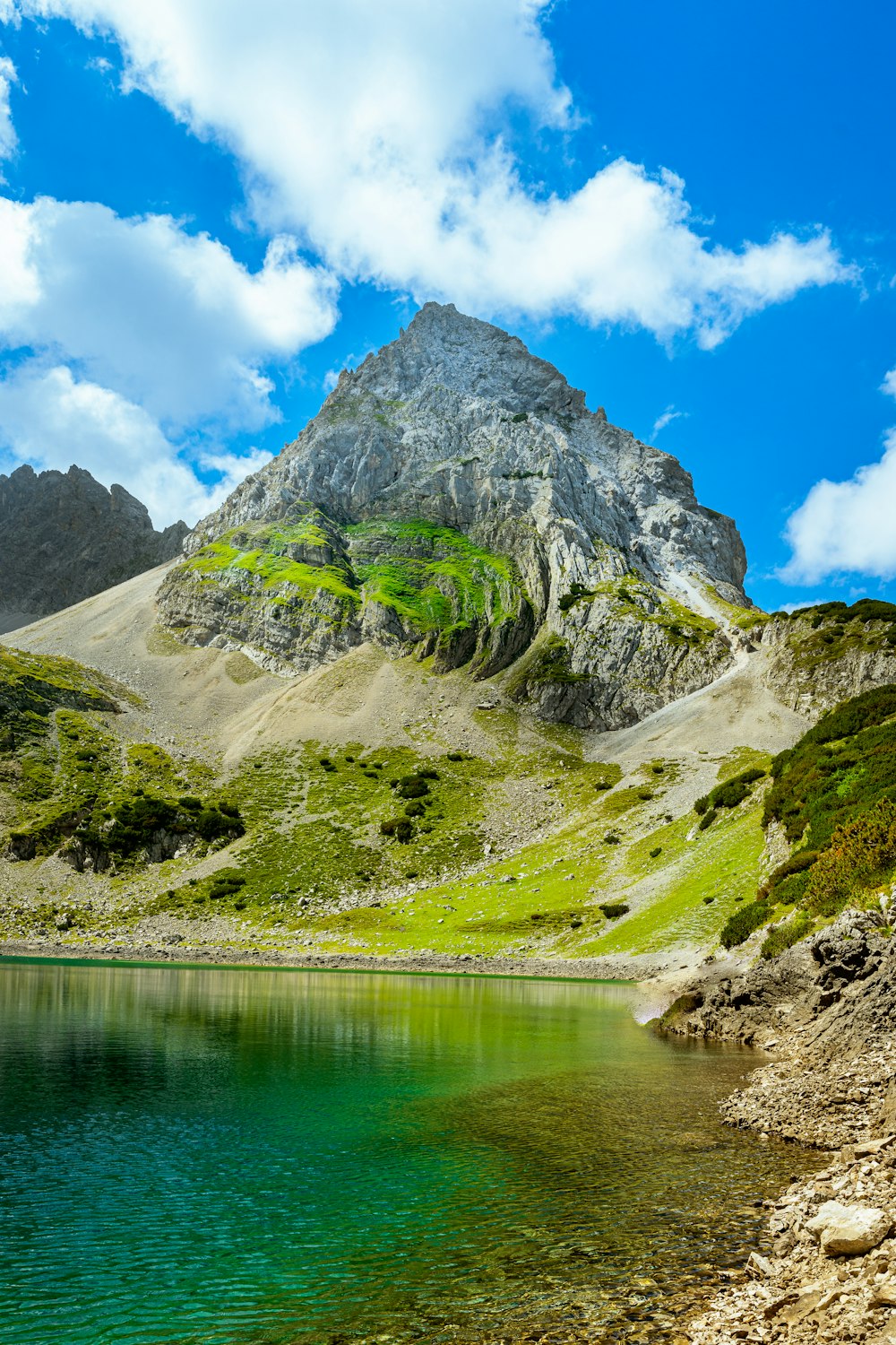 a body of water with a mountain in the background