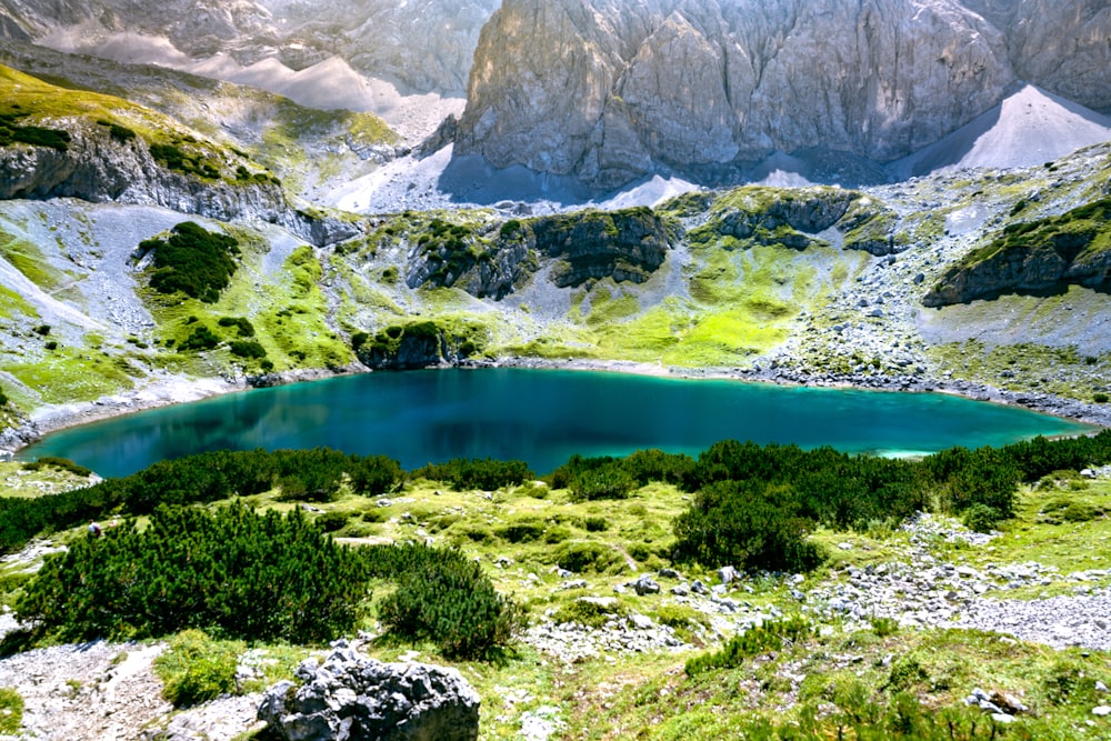 a lake surrounded by rocky mountains