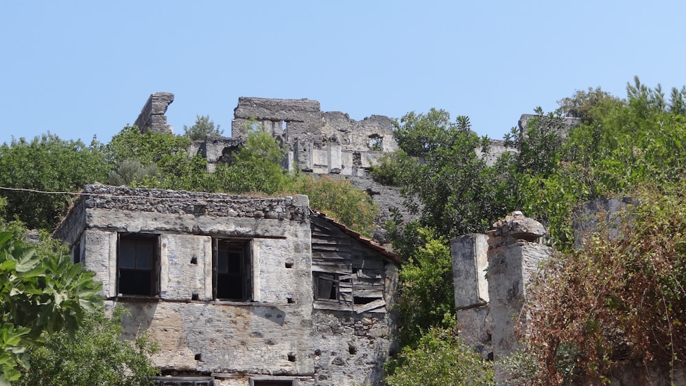 a stone building surrounded by trees