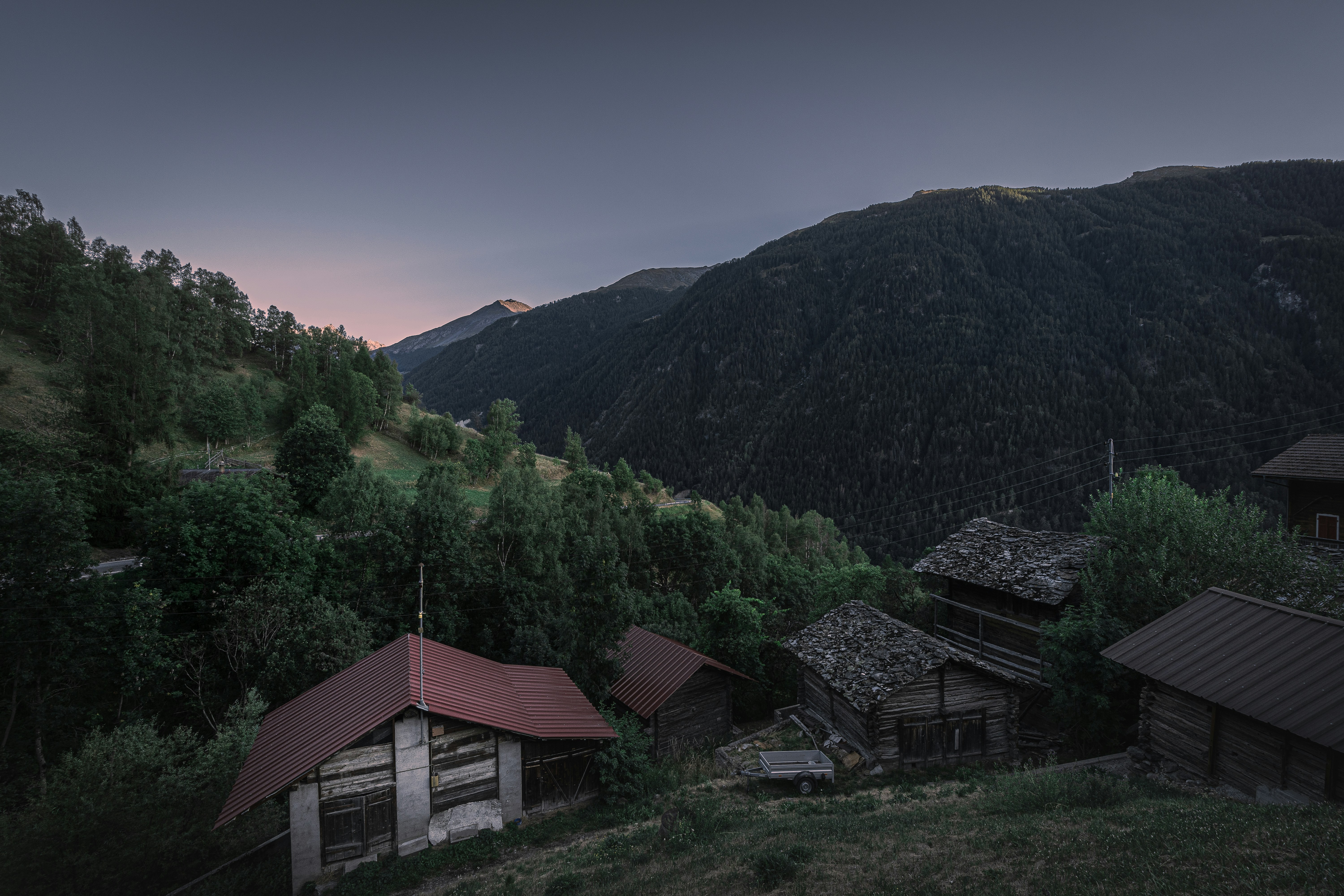 a group of buildings in front of a mountain