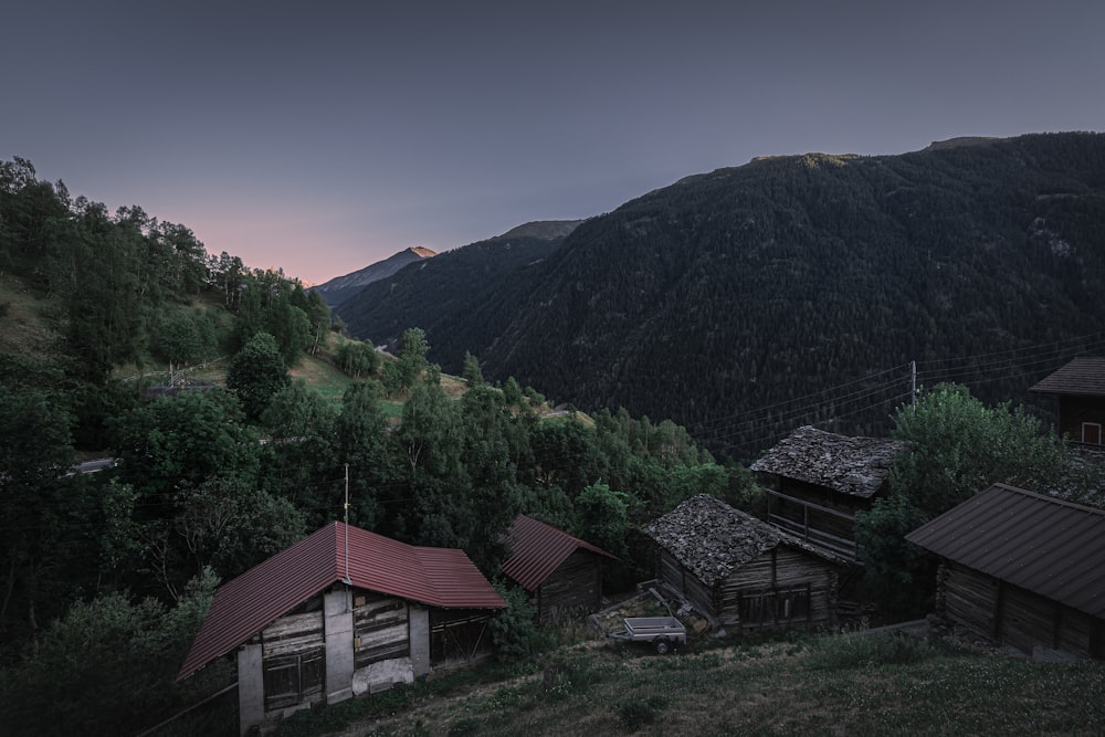 a group of buildings in front of a mountain