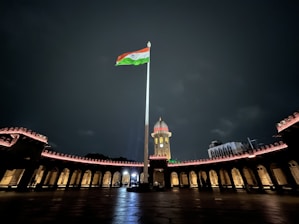 a flag on a pole in front of a bridge