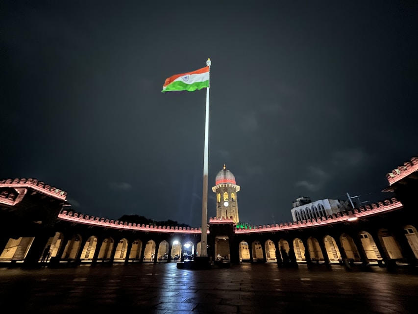 a flag on a pole in front of a bridge