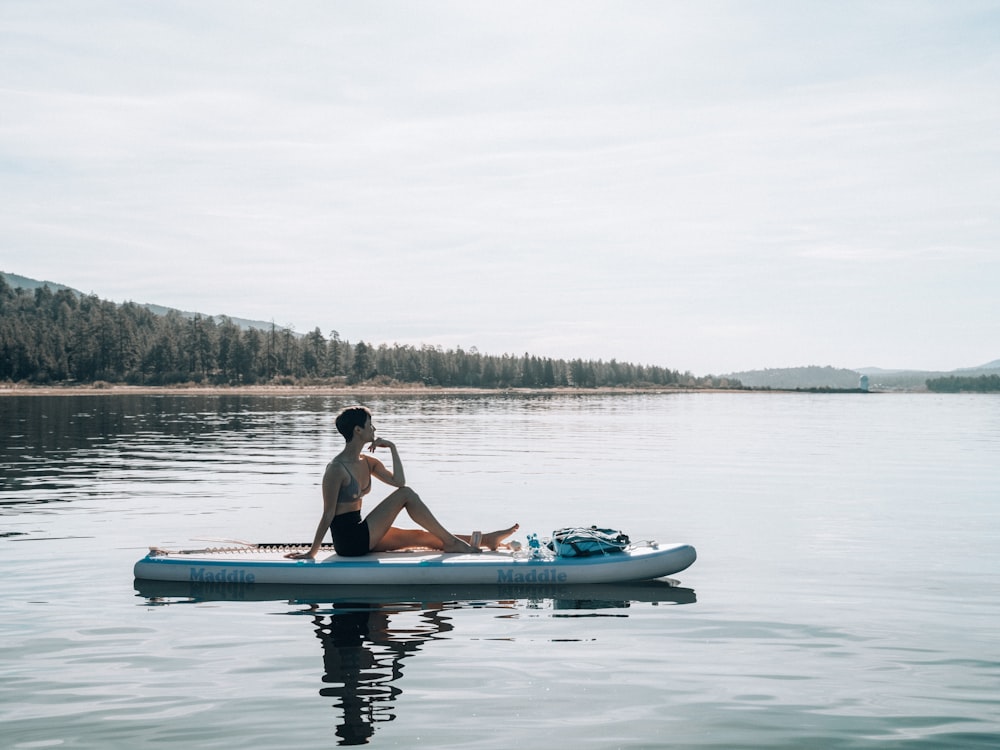 a man sitting on a paddle board