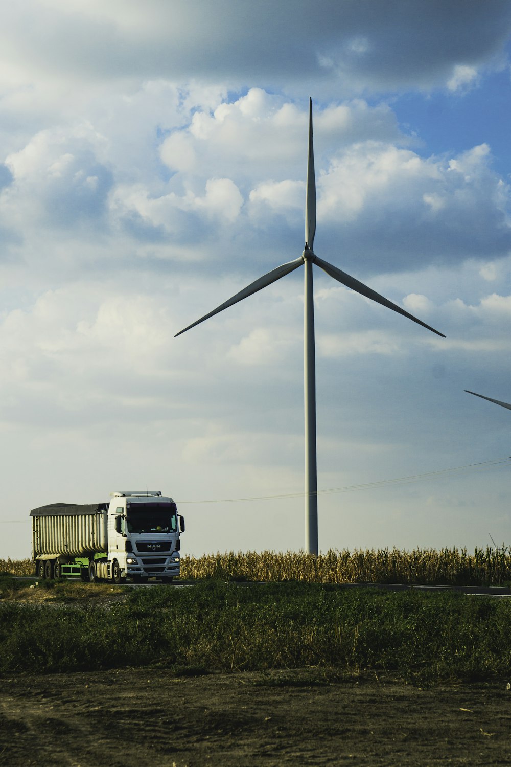 a truck parked next to a windmill