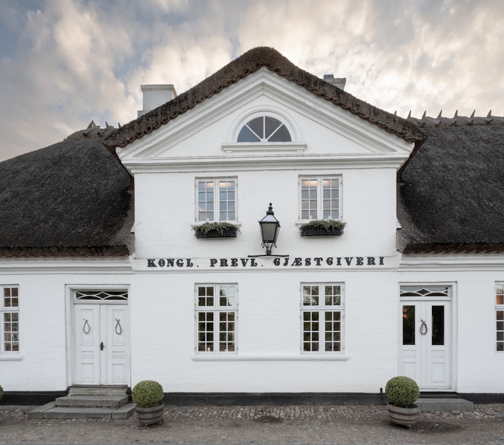 a white building with a black roof