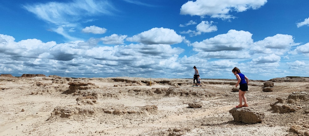 a group of people on a sandy beach