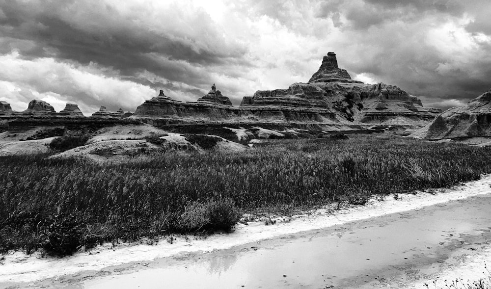 a black and white photo of a desert landscape with a few large rocks