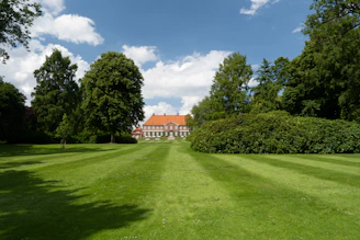A welcoming residential building with well-maintained landscaping under a clear blue sky.