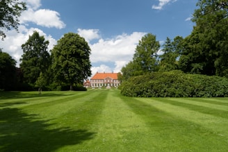A welcoming image of the school building surrounded by greenery.