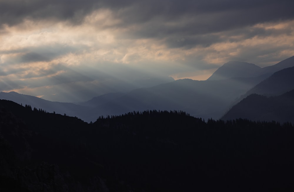 a landscape with mountains and clouds