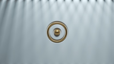 Close-up of the sleek steel MF Ring glowing softly against a dark background.