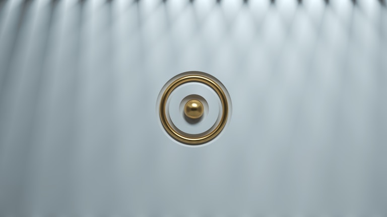 Close-up of the sleek steel mf ring glowing softly against a dark background.