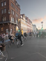 A vibrant city street with cyclists riding past.