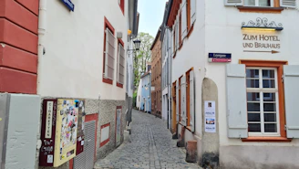 Historic brewery facade in Angers with vintage signage and cobblestone street.