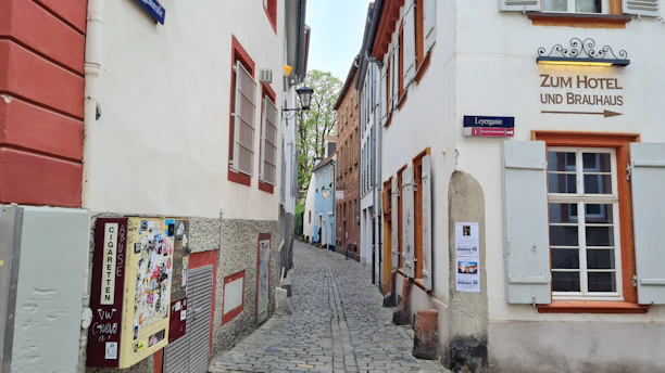 Historic brewery facade in Angers with vintage signage and cobblestone street.