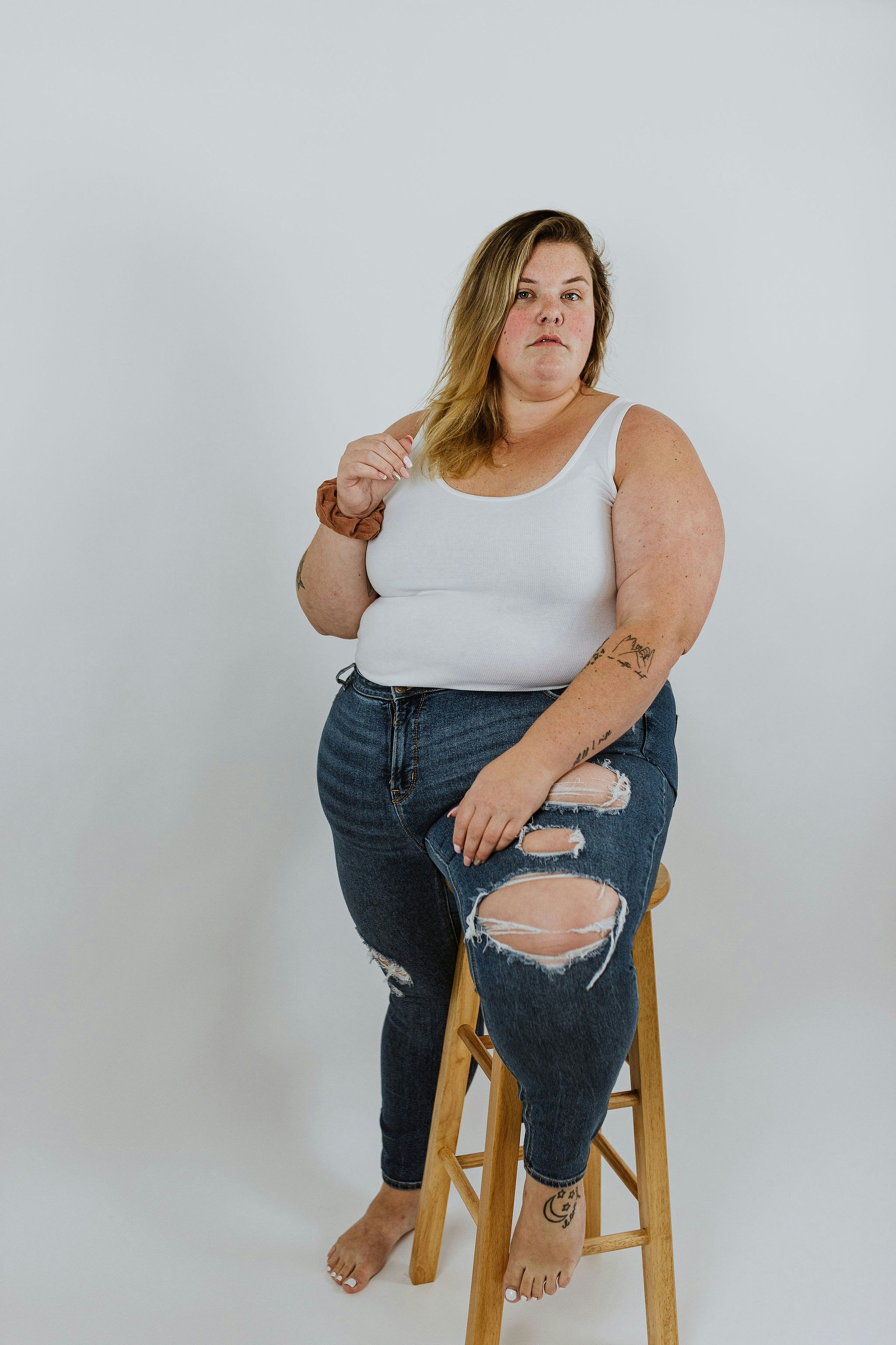 a woman sitting on a stool