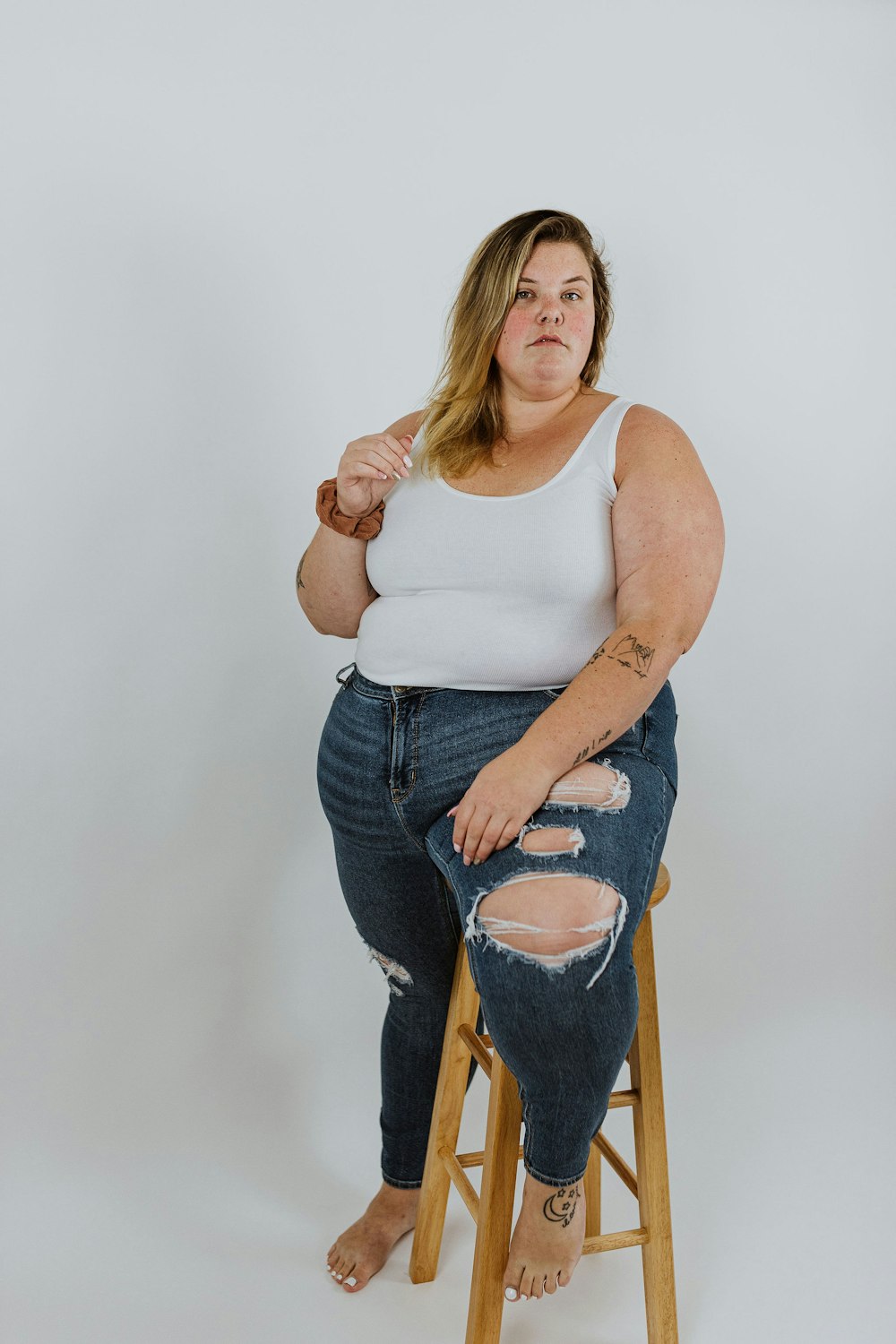 a woman sitting on a stool