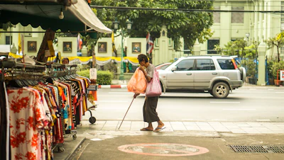 a person walking down the street with a cane