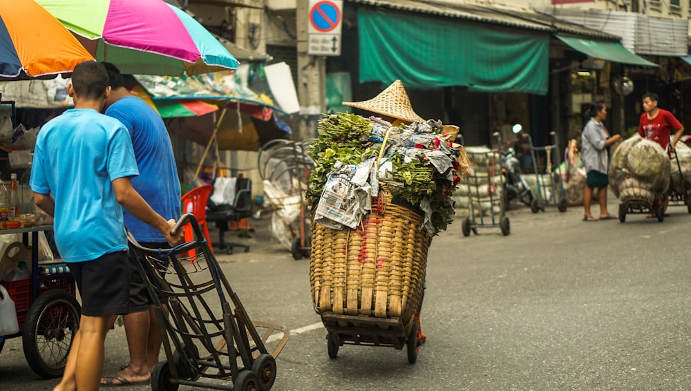 a person pushing a cart full of produce