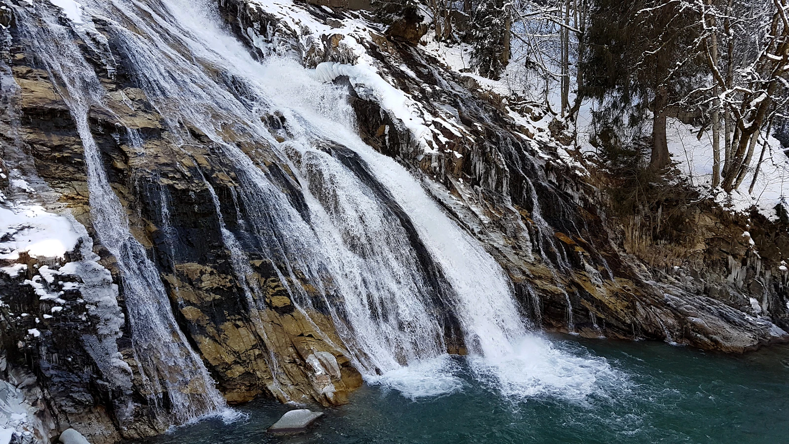 The waterfall frozen where it drops through the middle of Bad Gastein