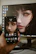 Close-up of hands holding a smartphone displaying a digital NFT artwork.
