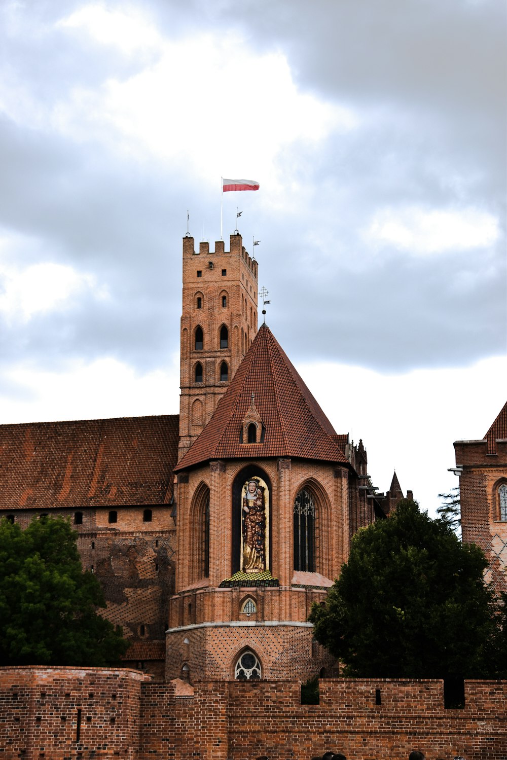 a brick building with a flag on top