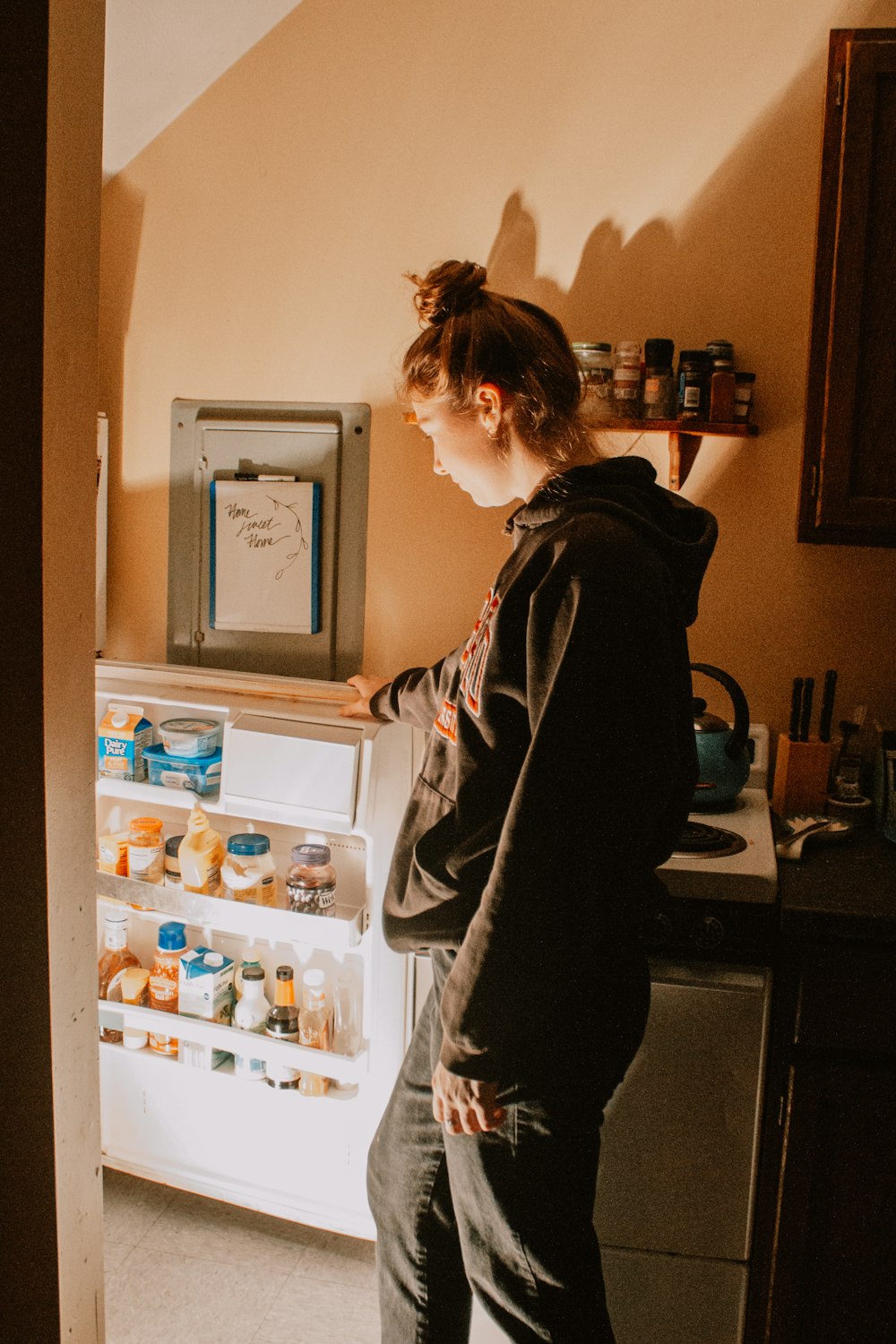 a person opens a refrigerator