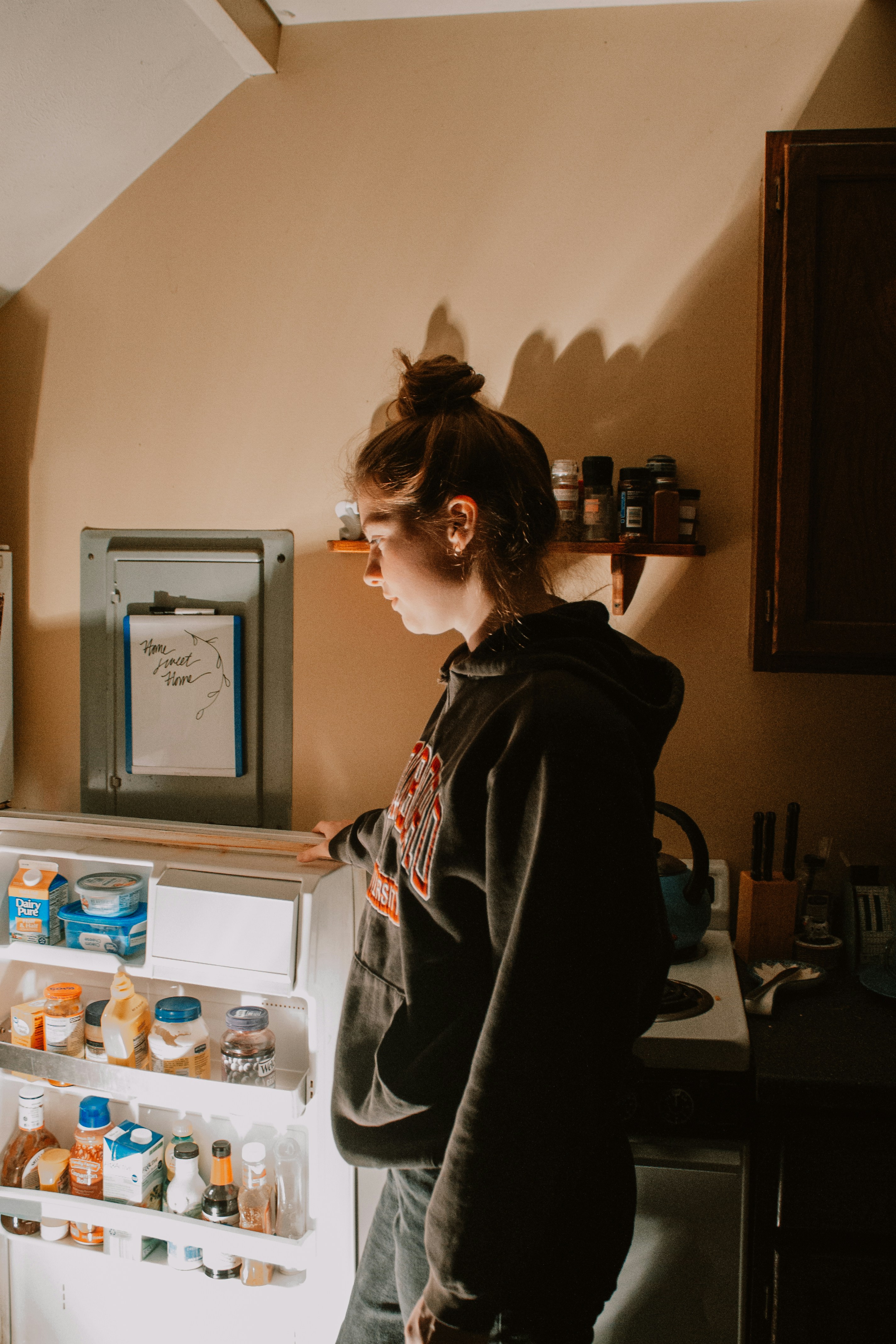 a person stands in front of a refrigerator