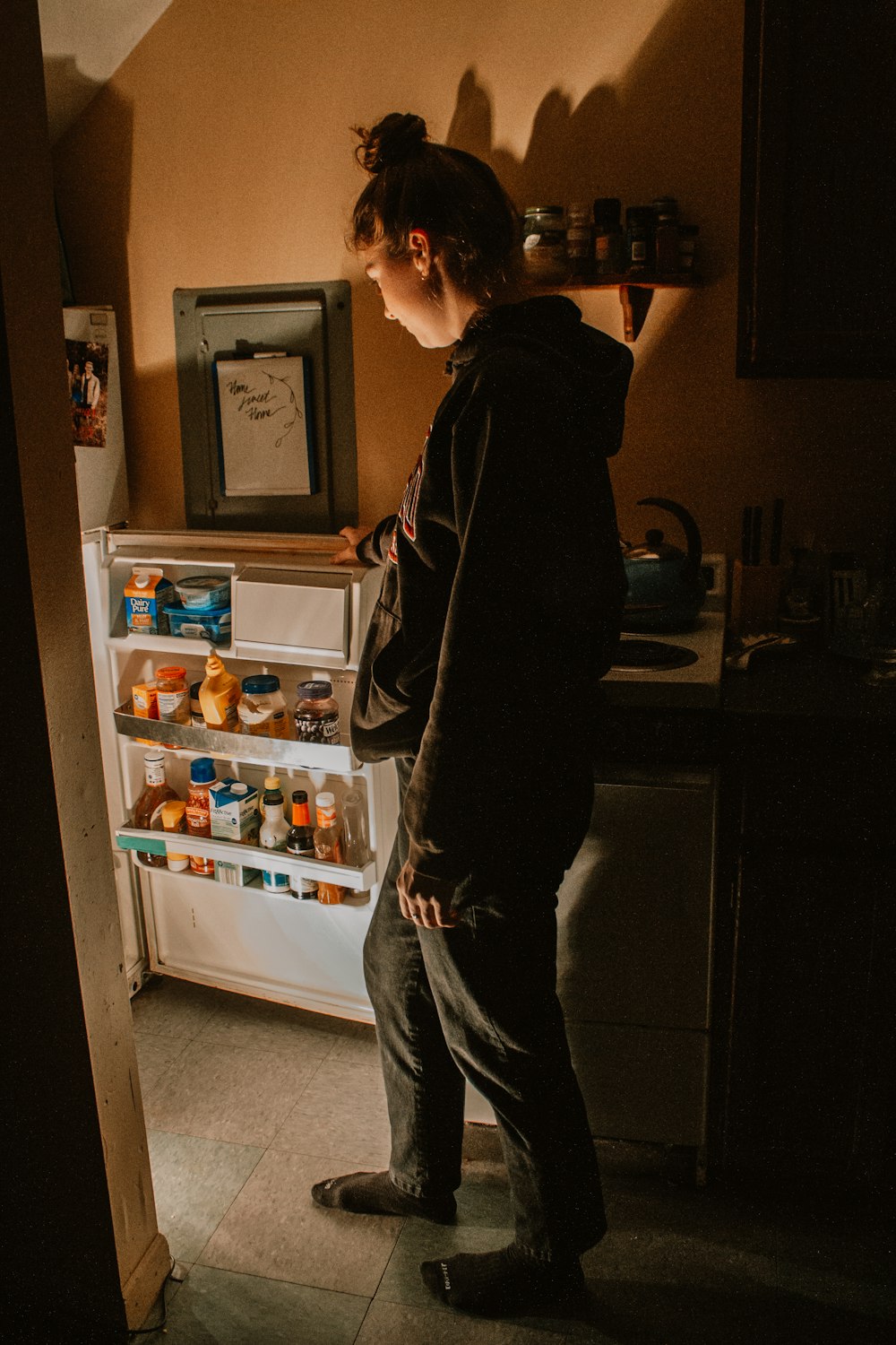 a man standing in front of a refrigerator