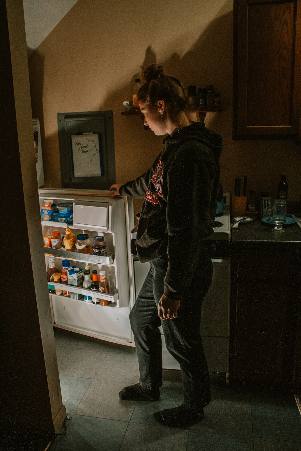 a person stands in front of a refrigerator