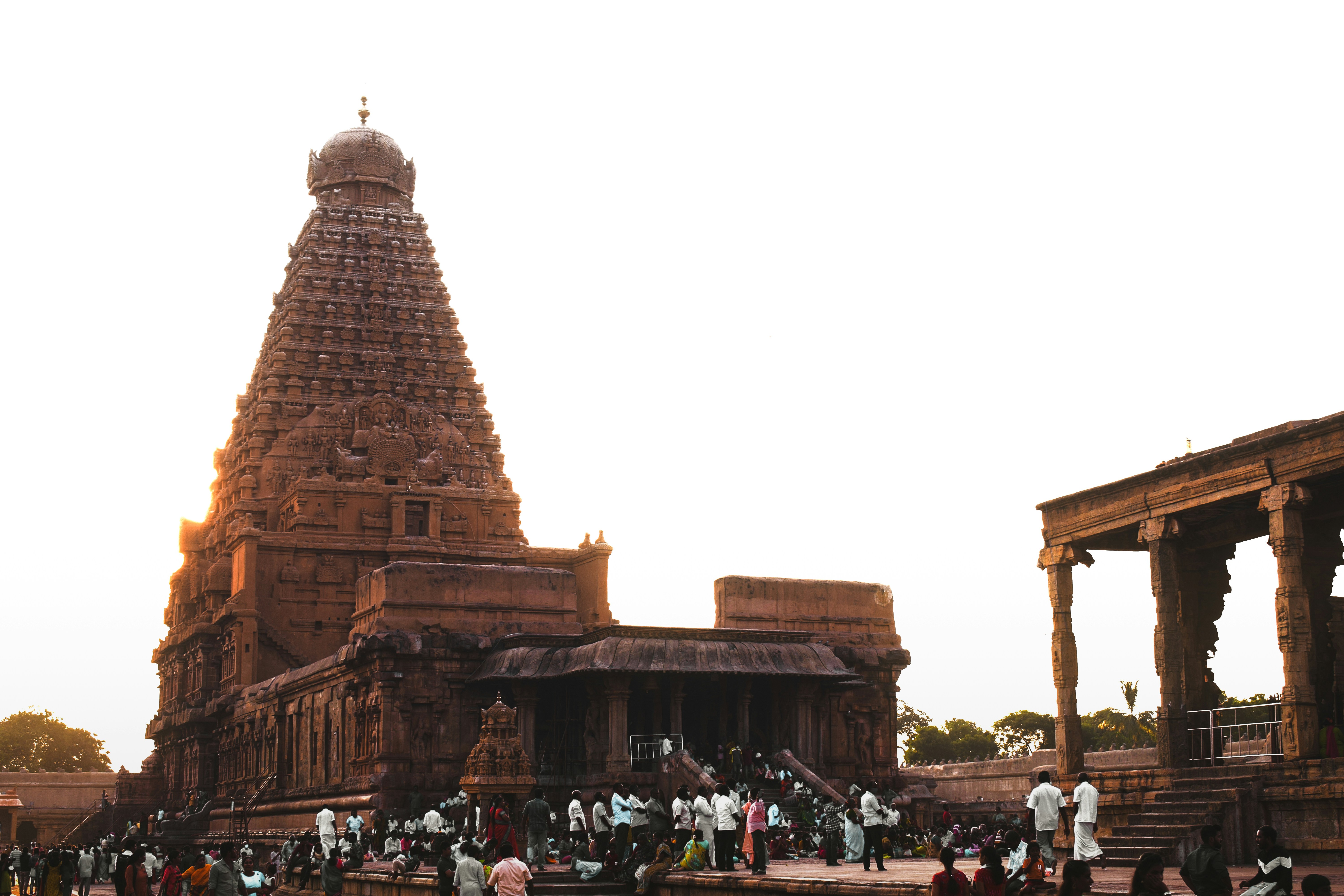 a large temple with people standing around with Brihadeeswarar Temple in the background