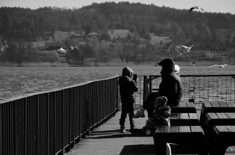 a group of people stand on a pier