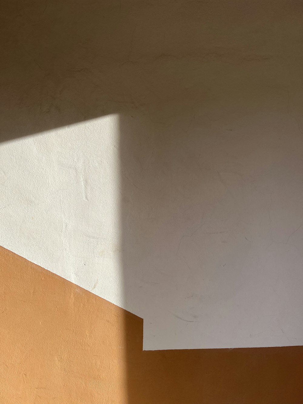 a white wall with a brown surface
