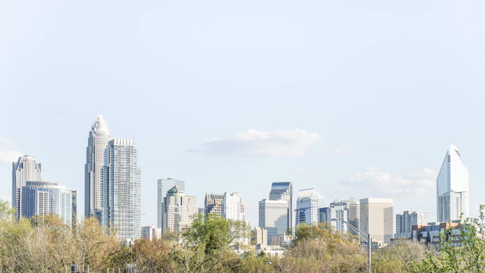 Charlotte skyline rising above trees