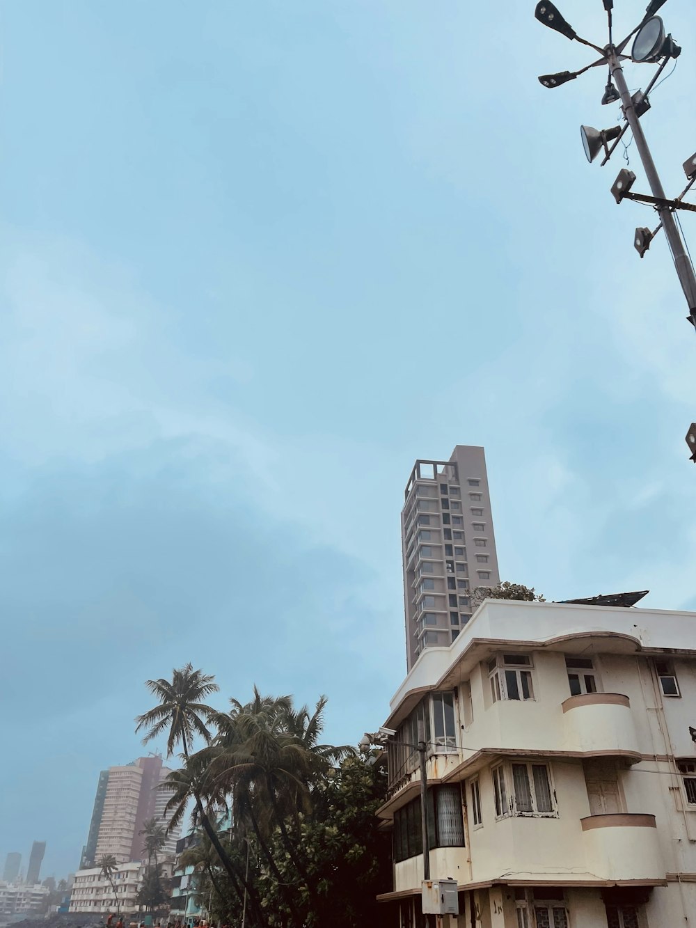 a group of buildings with trees in the front