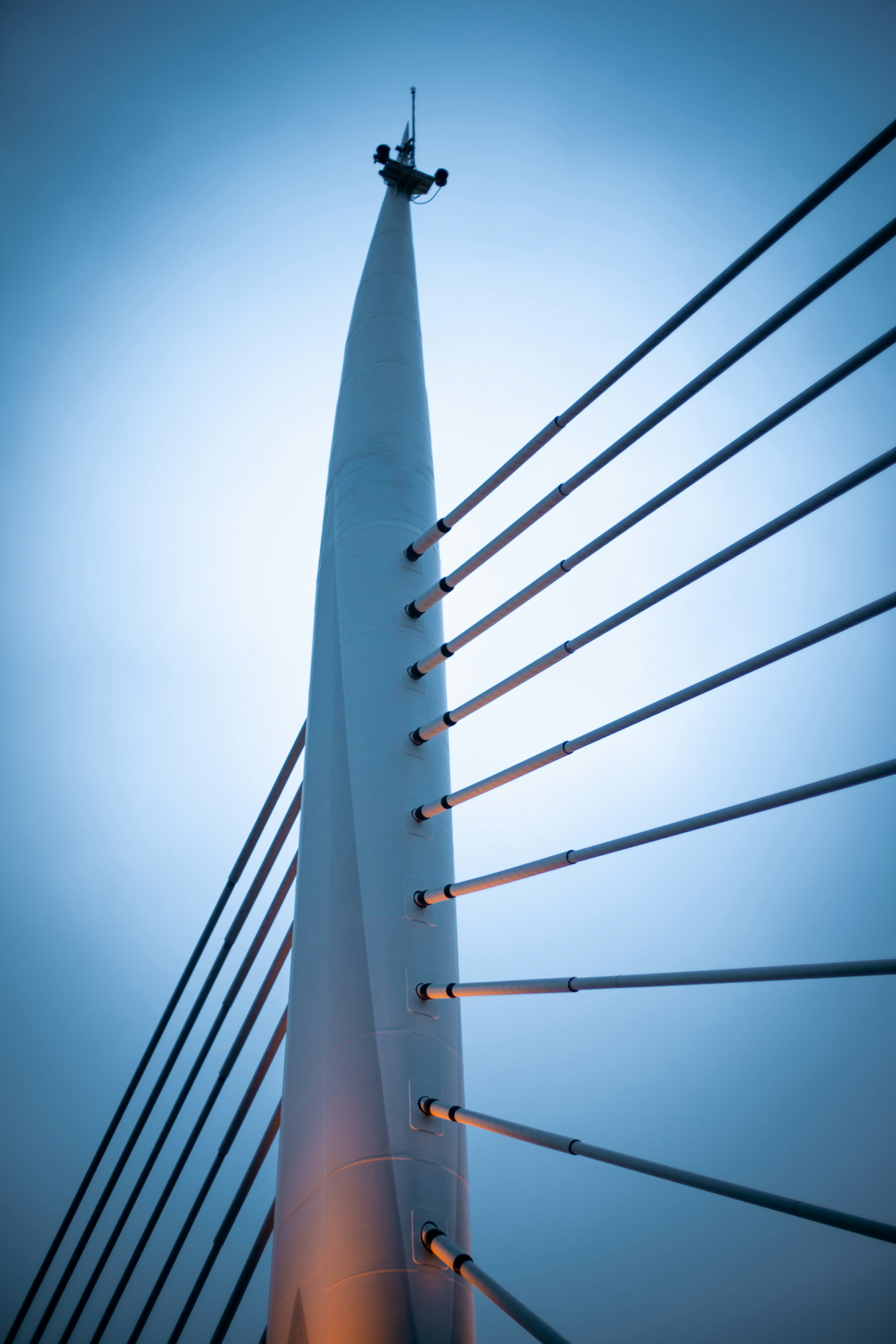 a tall tower with cables