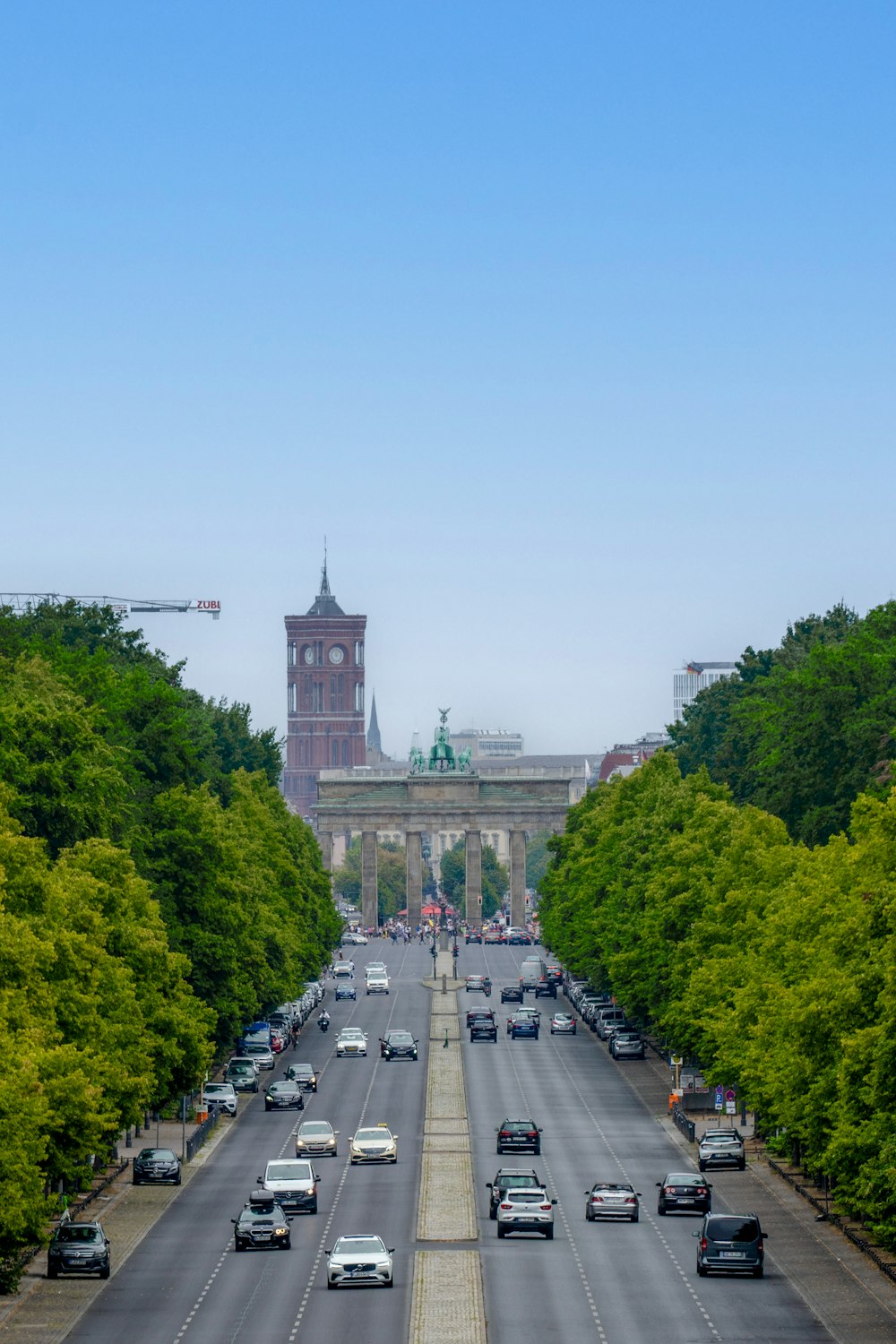 a road with cars on it and a tower in the distance