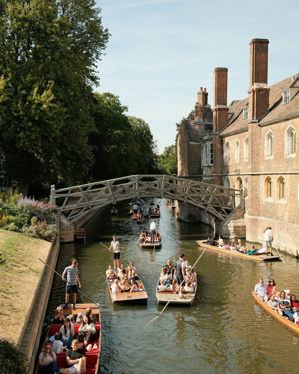 a group of people on boats in a canal