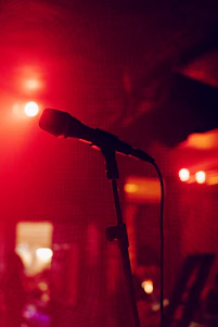 A cozy fireside setting with a microphone and warm lighting, inviting intimate conversation.