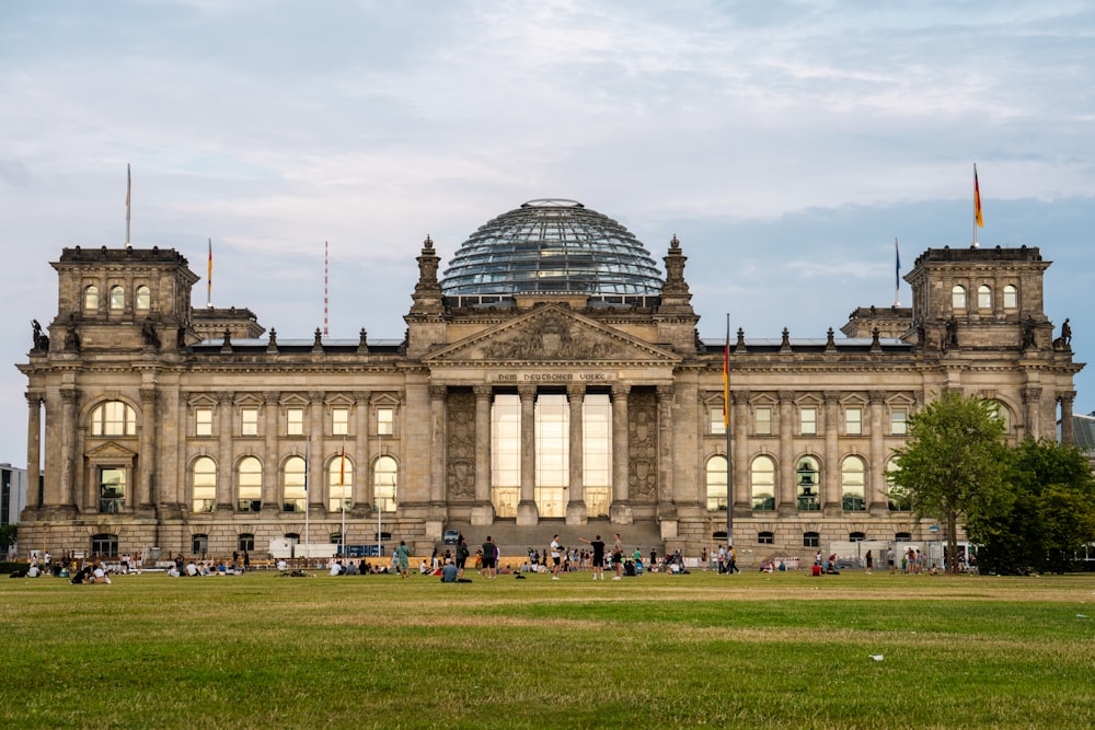 a large building with a dome roof with Reichstag building in the background