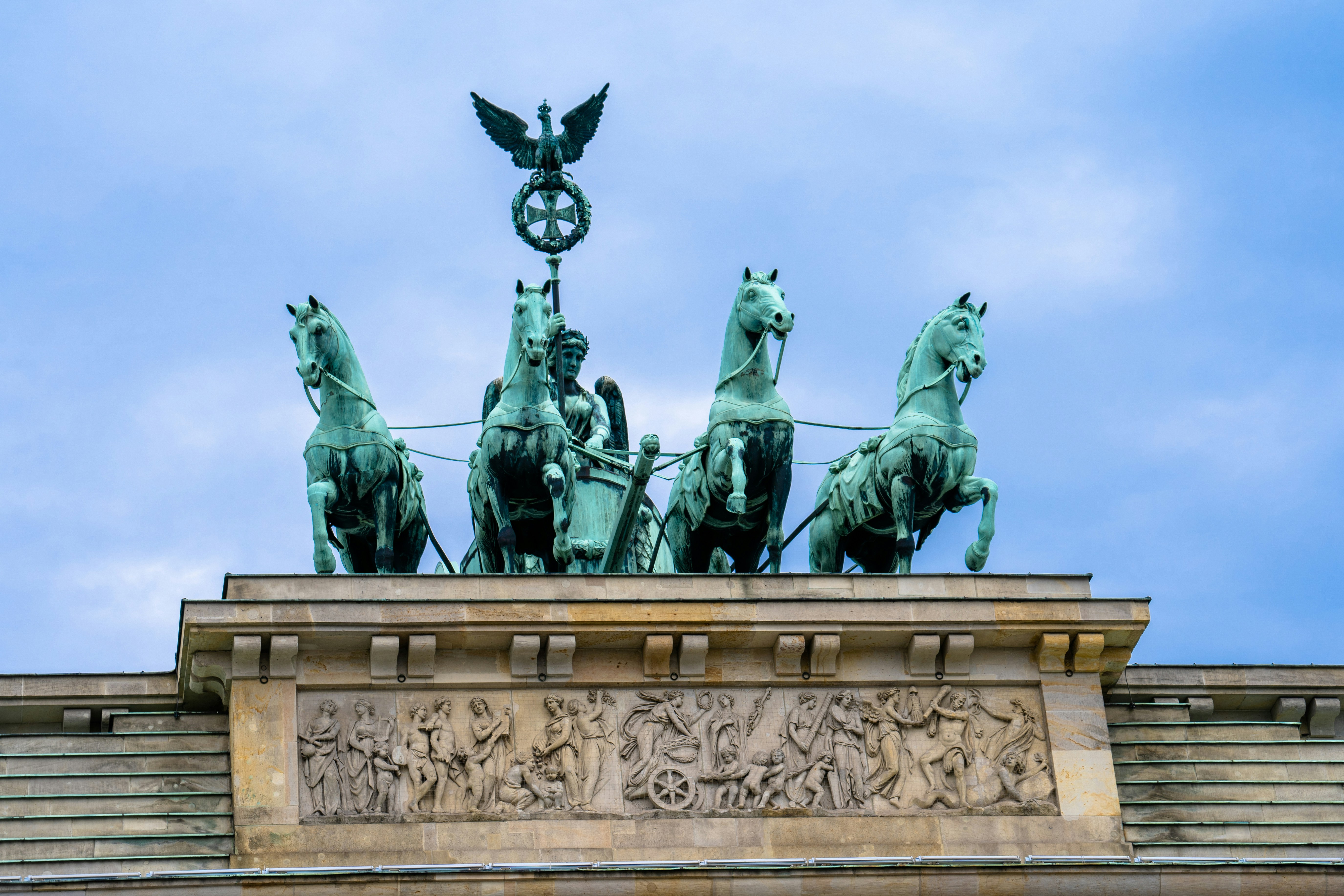 The statue of a Quadriga - a chariot drawn by four horses - driven by Victoria. As seen atop Brandenburger Tor (Brandenburg Gate), in Berlin, Germany.