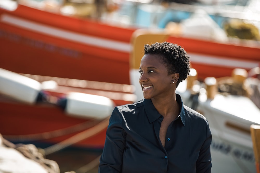 a person smiling in front of a boat