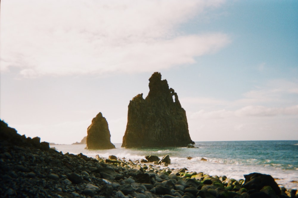 a group of large rocks in the ocean