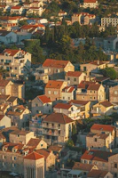 A charming medieval village with traditional houses and cobblestone streets bathed in golden sunlight