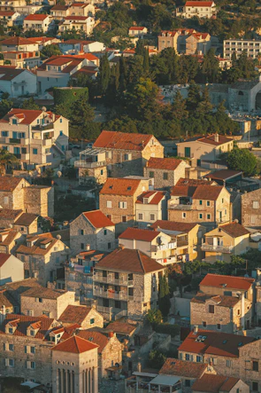 A charming medieval village with traditional houses and cobblestone streets bathed in golden sunlight
