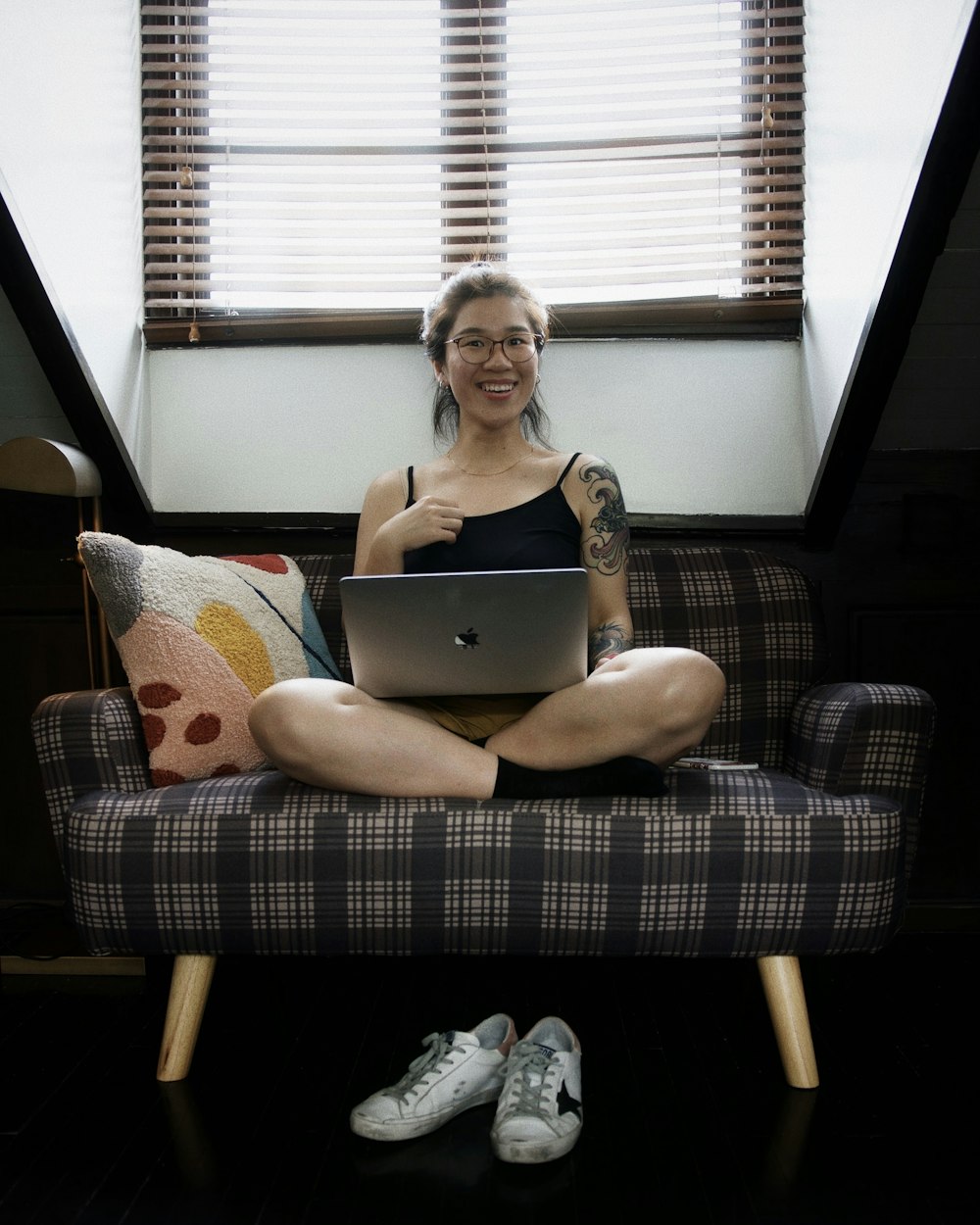 a person sitting on a couch with a laptop