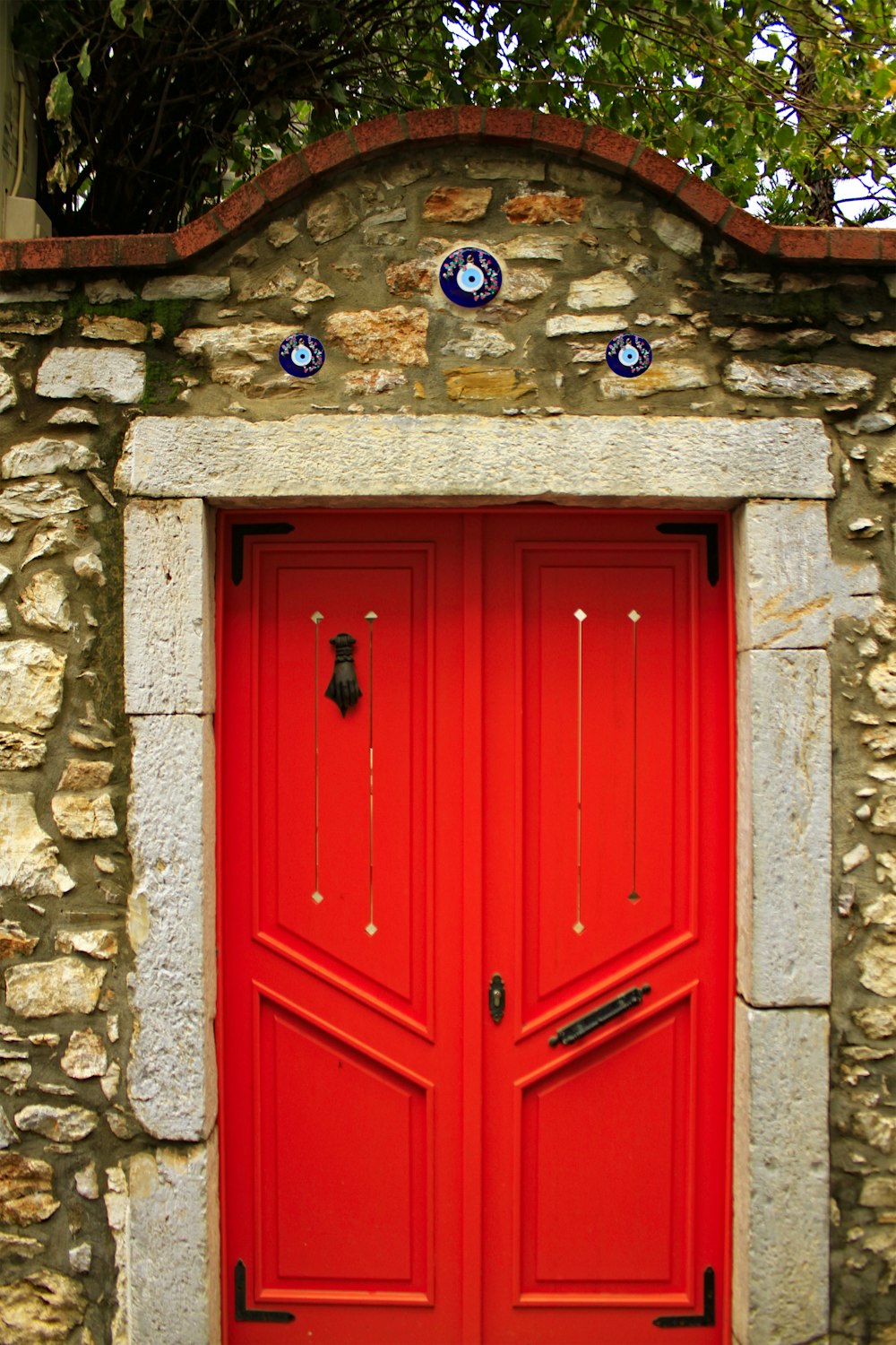 a red door on a stone building